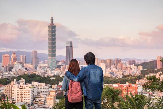 Young couple traveler looking beautiful cityscape at sunset in Taipei, Travel lifestyle