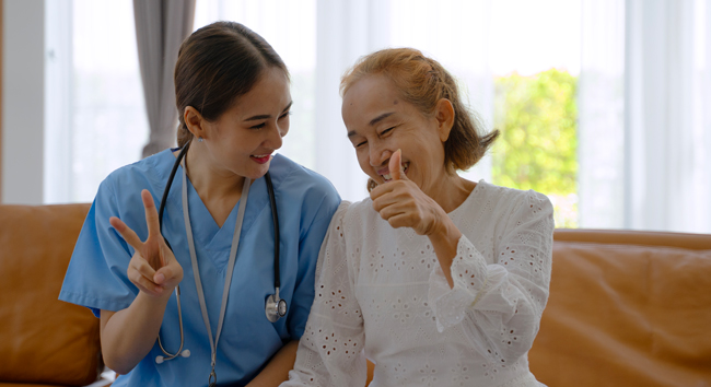 A nurse is taking care of a senior woman at home.
